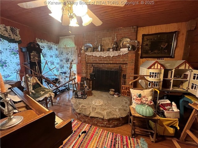 103 Chestnut Dr, Peytona, WV 25154 - living area featuring a ceiling fan, wood finished floors, wooden walls, a fireplace, and wooden ceiling