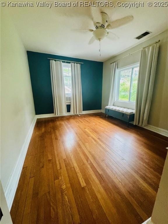 930 Mathews Ave, Charleston, WV 25302 - unfurnished room featuring plenty of natural light, wood finished floors, baseboards, and a ceiling fan