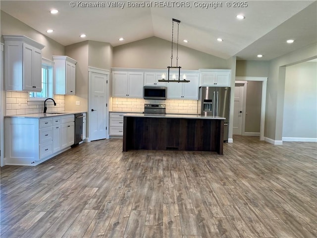 41 Day Star Dr, Evans, WV 25241 - kitchen with stainless steel appliances, a sink, wood finished floors, light countertops, and lofted ceiling