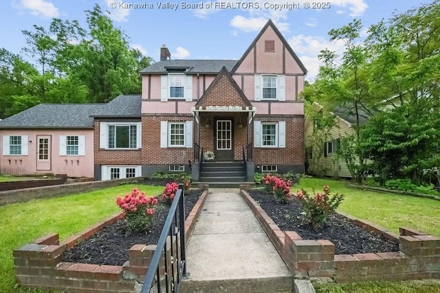 608 Kanawha Ave, Clendenin, WV 25045 - tudor house with a front lawn, stucco siding, brick siding, and a chimney