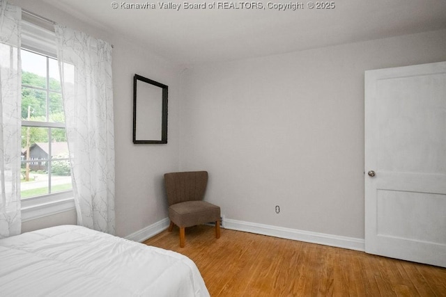 608 Kanawha Ave, Clendenin, WV 25045 - bedroom with multiple windows, wood finished floors, and baseboards