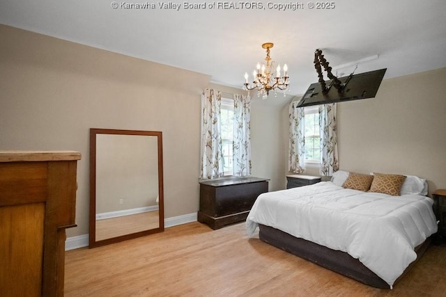 608 Kanawha Ave, Clendenin, WV 25045 - bedroom with a chandelier, light wood-style flooring, and baseboards