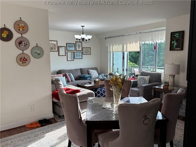 1800 Roundhill Rd Unit 901, Charleston, WV 25304 - dining area featuring a chandelier, wood finished floors, and baseboards