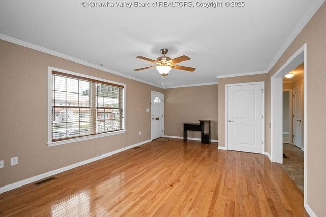 5211 Ohio St, South Charleston, WV 25309 - unfurnished living room with light wood-type flooring, crown molding, ceiling fan, and baseboards
