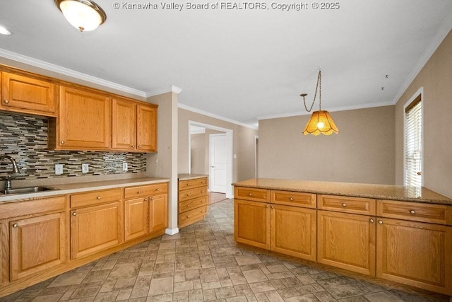 5211 Ohio St, South Charleston, WV 25309 - kitchen featuring a sink, crown molding, light countertops, backsplash, and pendant lighting