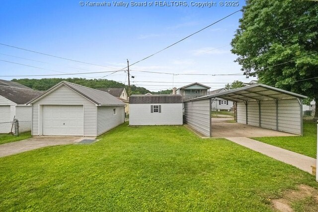 5211 Ohio St, South Charleston, WV 25309 - view of yard with an outdoor structure, concrete driveway, a carport, and a garage