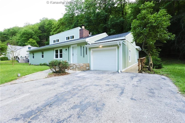 717 Chappell Rd, Charleston, WV 25304 - view of front of house featuring a garage, driveway, a chimney, a front yard, and board and batten siding