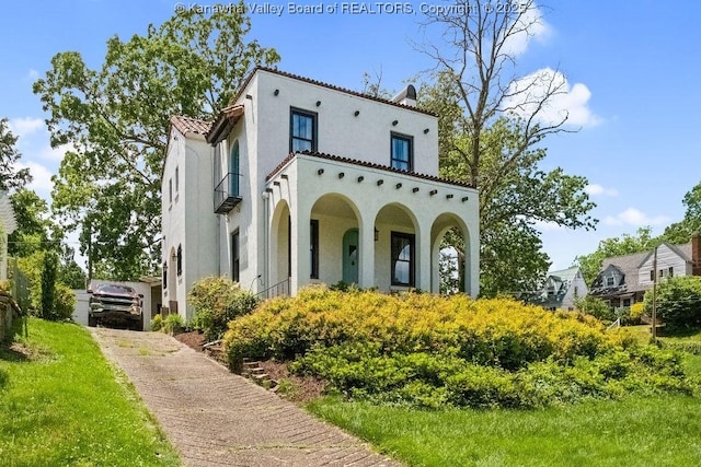 606 Fort Hill Dr, Charleston, WV 25314 - mediterranean / spanish-style house featuring stucco siding, a tile roof, and a balcony