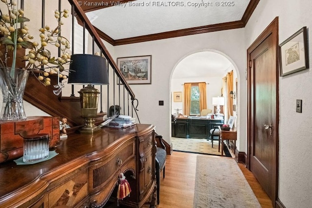 606 Fort Hill Dr, Charleston, WV 25314 - foyer entrance with wood finished floors, arched walkways, stairs, crown molding, and baseboards