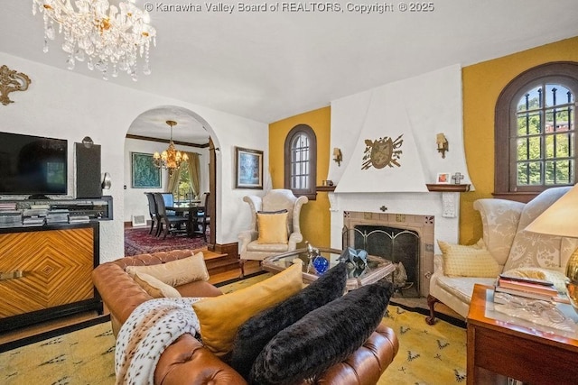606 Fort Hill Dr, Charleston, WV 25314 - living area featuring a chandelier, arched walkways, plenty of natural light, and a fireplace