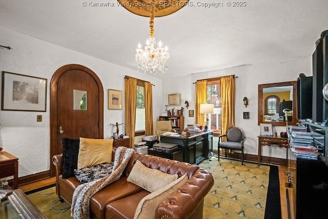 606 Fort Hill Dr, Charleston, WV 25314 - living room featuring a chandelier, baseboards, a textured wall, and wood finished floors
