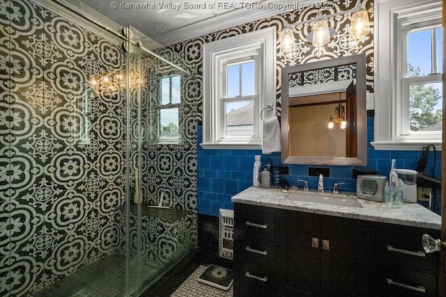 606 Fort Hill Dr, Charleston, WV 25314 - bathroom with tile walls, vanity, walk in shower, ornamental molding, and a chandelier