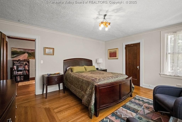 606 Fort Hill Dr, Charleston, WV 25314 - bedroom featuring a textured ceiling, a chandelier, light wood finished floors, baseboards, and ornamental molding