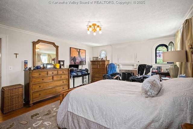 606 Fort Hill Dr, Charleston, WV 25314 - bedroom with wood finished floors, a textured ceiling, and ornamental molding