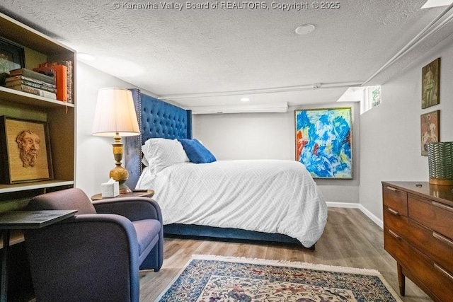 606 Fort Hill Dr, Charleston, WV 25314 - bedroom with wood finished floors, a textured ceiling, and baseboards