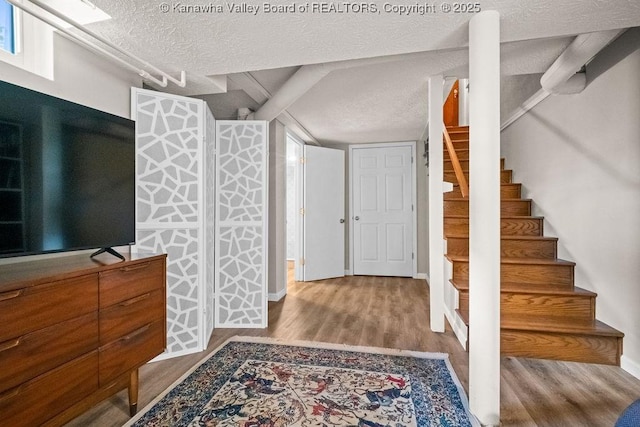 606 Fort Hill Dr, Charleston, WV 25314 - entrance foyer featuring a textured ceiling, wood finished floors, stairs, and baseboards