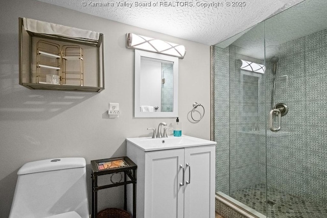 606 Fort Hill Dr, Charleston, WV 25314 - full bath featuring a stall shower, toilet, a textured ceiling, and vanity