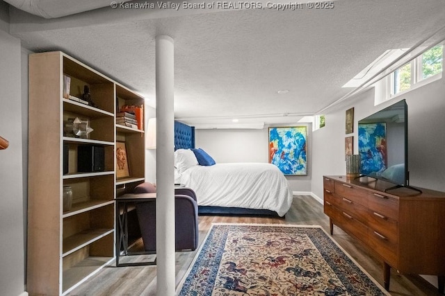 606 Fort Hill Dr, Charleston, WV 25314 - bedroom with wood finished floors, a textured ceiling, and baseboards