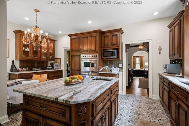 606 Fort Hill Dr, Charleston, WV 25314 - kitchen with appliances with stainless steel finishes, arched walkways, tasteful backsplash, recessed lighting, and glass insert cabinets