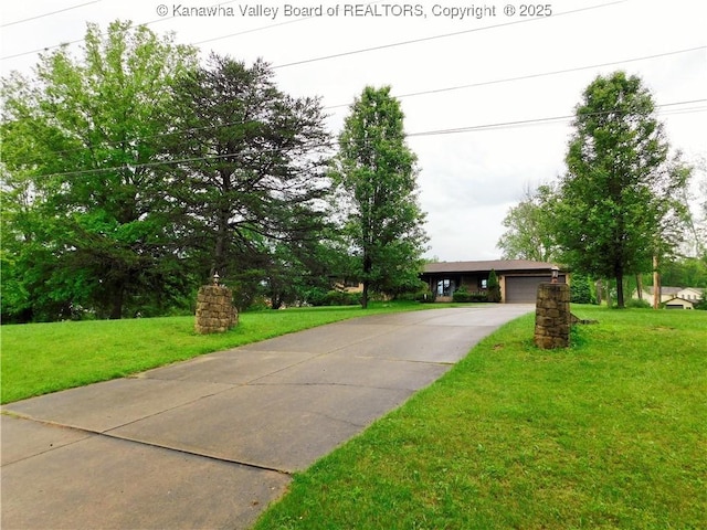 single story home featuring a front yard, a garage, and driveway