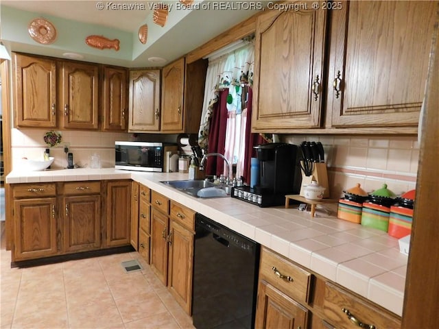 kitchen featuring black dishwasher, a sink, stainless steel microwave, and tasteful backsplash