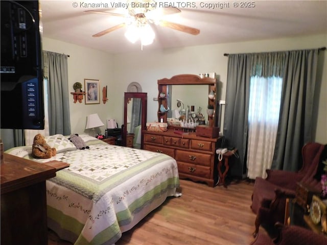 bedroom with wood finished floors and ceiling fan