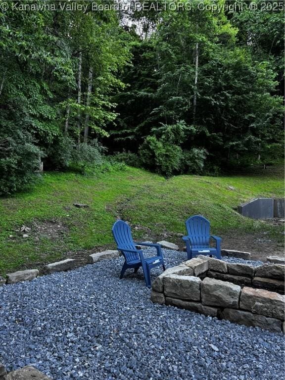 352 Hidden Valley Rd, Chapmanville, WV 25508 - view of yard with an outdoor fire pit and a view of trees