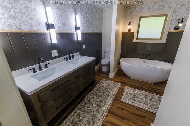 352 Hidden Valley Rd, Chapmanville, WV 25508 - full bathroom with wallpapered walls, wainscoting, wood finished floors, a soaking tub, and toilet