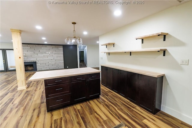 352 Hidden Valley Rd, Chapmanville, WV 25508 - kitchen with open shelves, wood finished floors, butcher block countertops, a fireplace, and recessed lighting