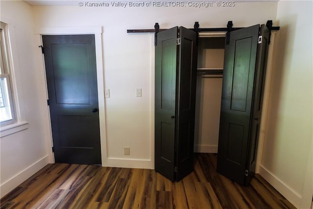 352 Hidden Valley Rd, Chapmanville, WV 25508 - unfurnished bedroom with dark wood finished floors, baseboards, and a closet