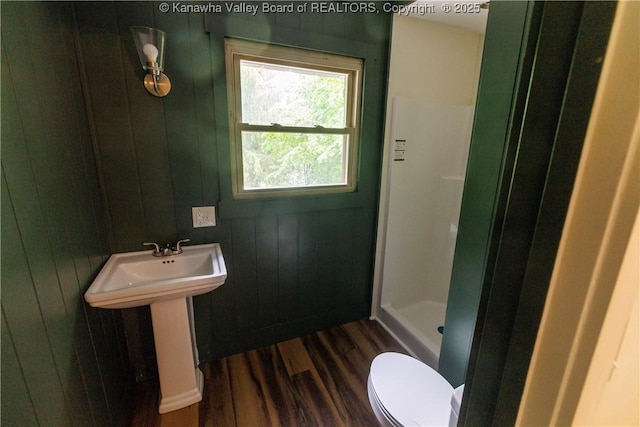 352 Hidden Valley Rd, Chapmanville, WV 25508 - bathroom with wood finished floors, a shower stall, toilet, a sink, and wood walls