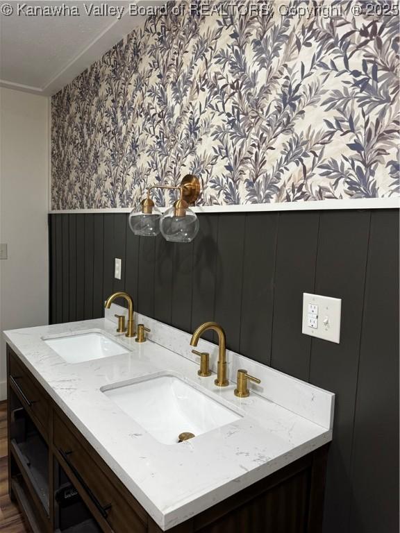 352 Hidden Valley Rd, Chapmanville, WV 25508 - bathroom with wallpapered walls, wainscoting, and double vanity