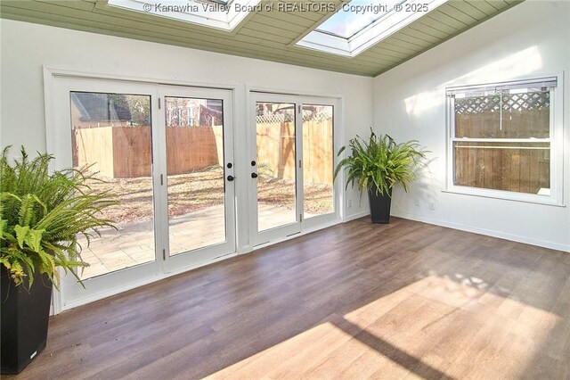 1505 Lee St E, Charleston, WV 25311 - spare room with a skylight, wood finished floors, french doors, baseboards, and vaulted ceiling