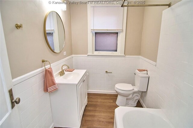 1505 Lee St E, Charleston, WV 25311 - full bathroom with tile walls, a wainscoted wall, toilet, wood finished floors, and vanity