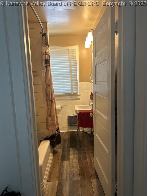 5505 Washington Ave, Charleston, WV 25304 - bathroom featuring wood-type flooring, vanity, a wainscoted wall, and shower / bathtub combination with curtain