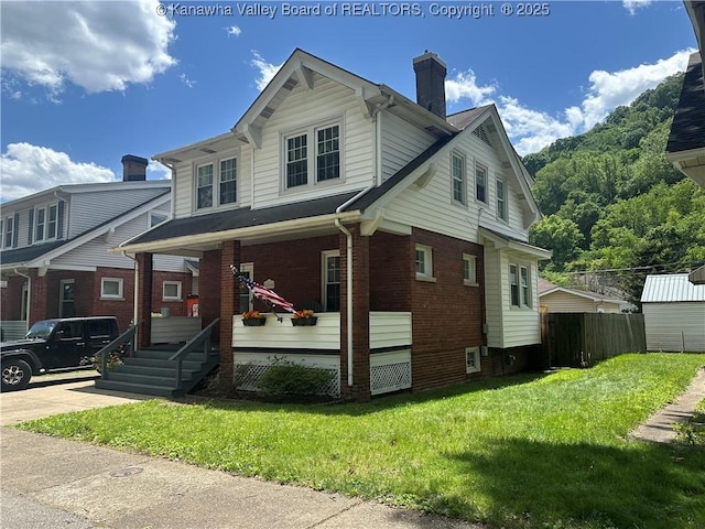 5505 Washington Ave, Charleston, WV 25304 - view of front of house with covered porch, brick siding, and a chimney