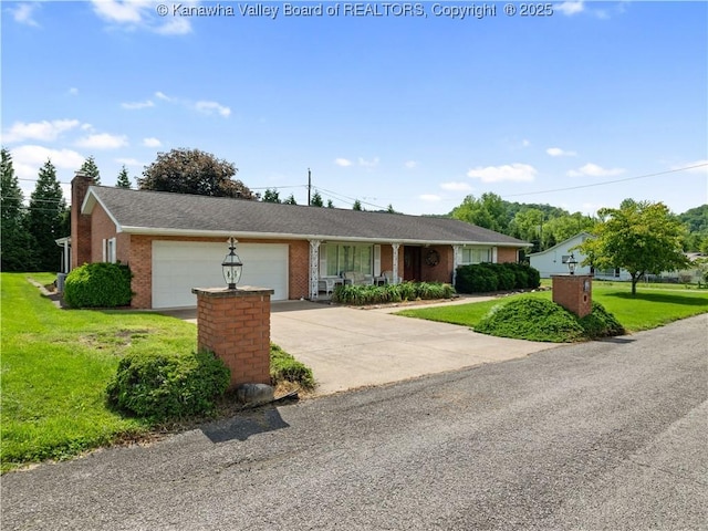 ranch-style house featuring a garage, a front yard, brick siding, driveway, and a chimney