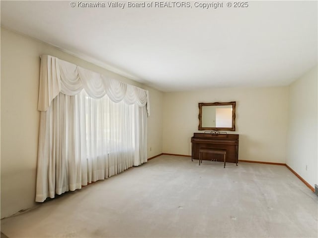 spare room with carpet flooring and baseboards