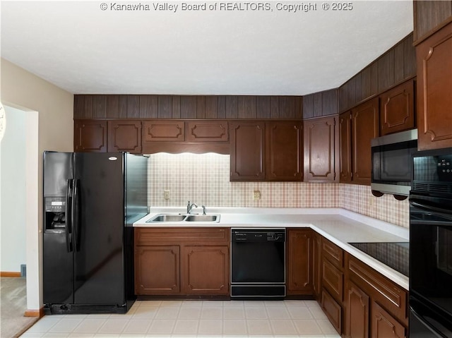 kitchen with black appliances, a sink, light countertops, and tasteful backsplash