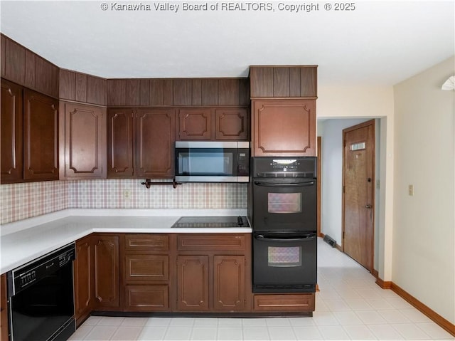 kitchen with black appliances, light countertops, and baseboards