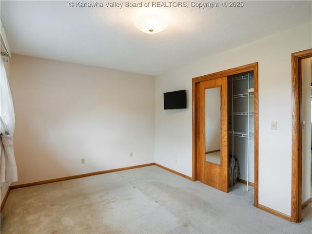 unfurnished bedroom with carpet floors, baseboards, and a closet
