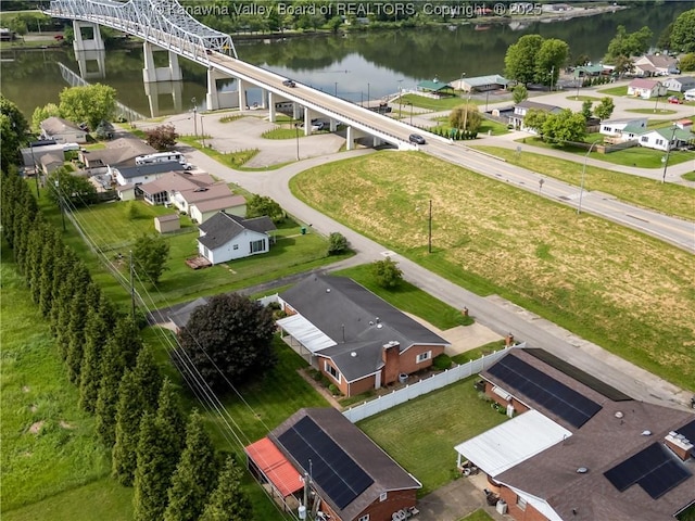 aerial perspective of suburban area featuring a nearby body of water and a notable bridge