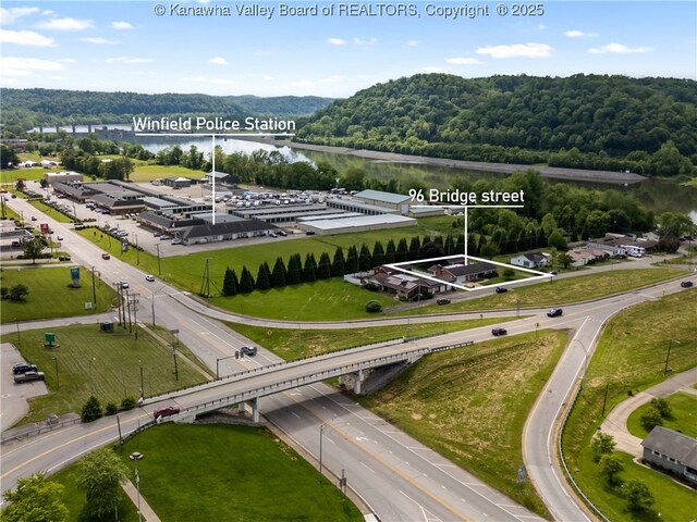 aerial overview of property's location with a nearby body of water, a forest, and property boundaries highlighted