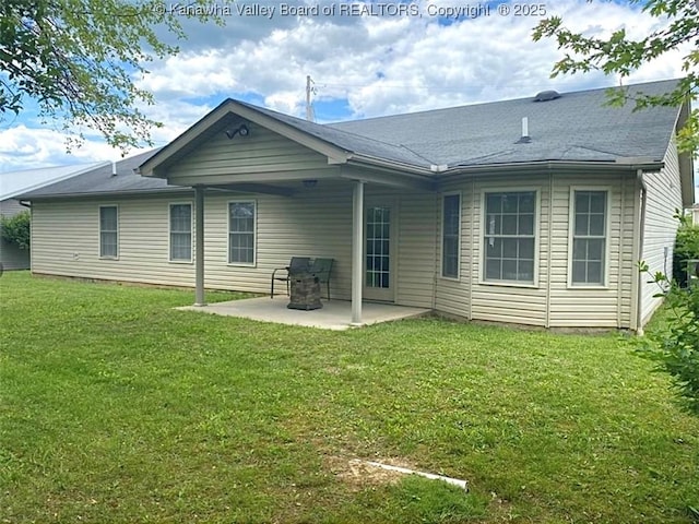 rear view of property featuring a patio area and a yard