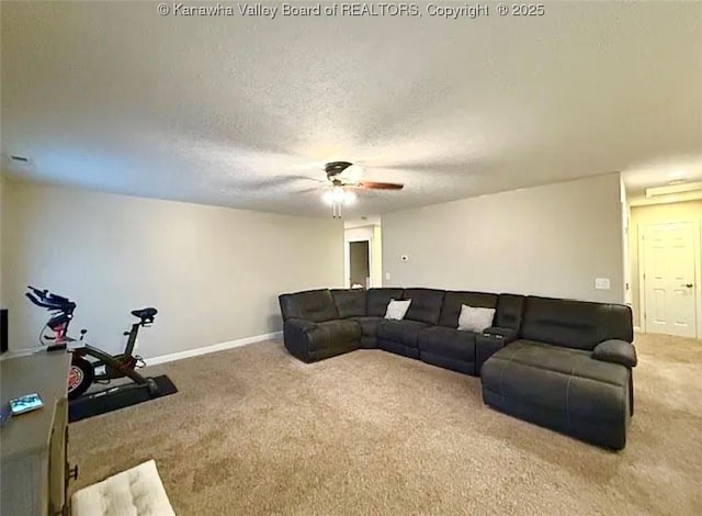 carpeted living room featuring a ceiling fan, a textured ceiling, and baseboards