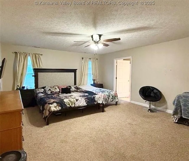 carpeted bedroom with multiple windows, a textured ceiling, baseboards, and ceiling fan