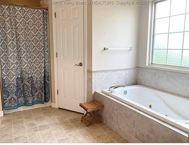 bathroom with a jetted tub and curtained shower