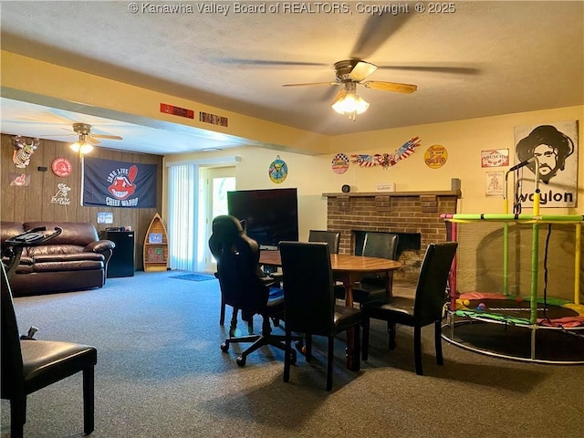 486 Woodland Acres Dr, Ripley, WV 25271 - carpeted dining space featuring a ceiling fan, a textured ceiling, wood walls, and a fireplace