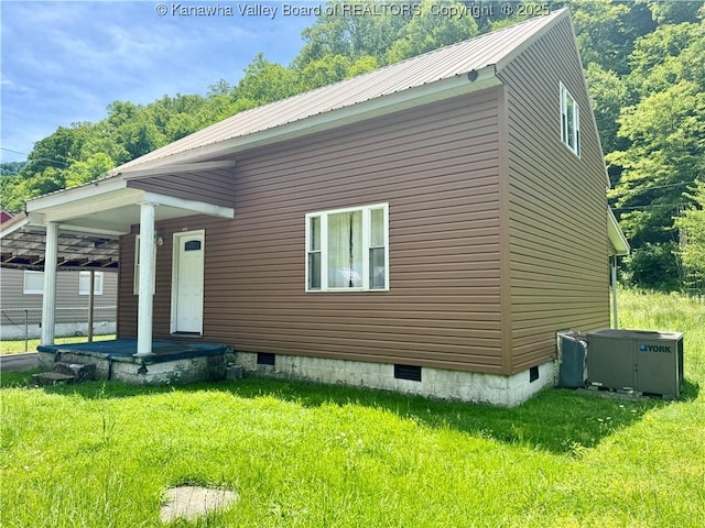 391 Mckinley St, Wharton, WV 25208 - view of side of home with crawl space, a lawn, and metal roof