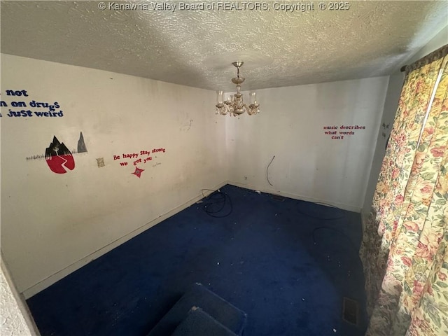 391 Mckinley St, Wharton, WV 25208 - unfurnished room featuring a textured ceiling and a chandelier